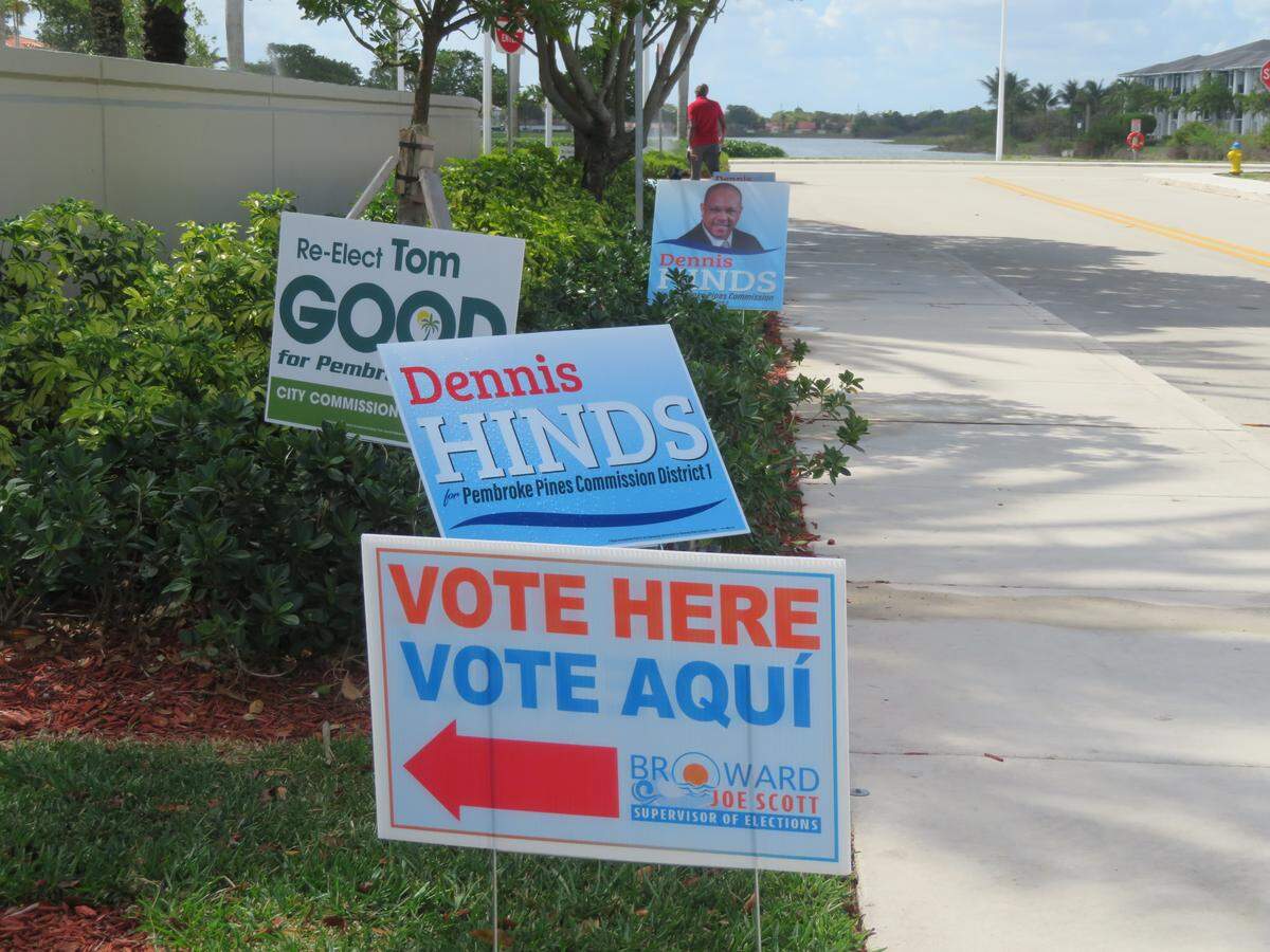 Candidate and voting signs outside of the Charles F. Dodge City Center polling site for the municipal election.