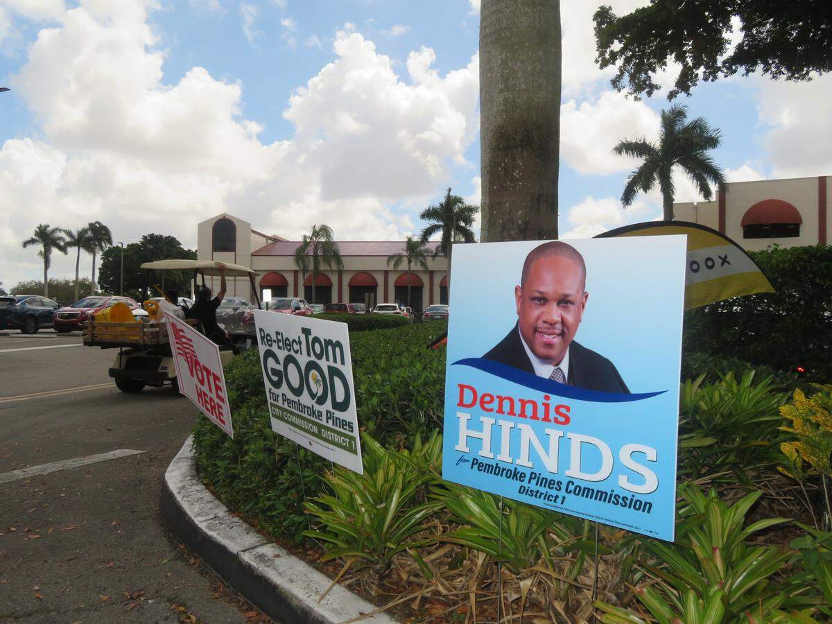 Candidate signs stand outside of the Hollybrook Golf and Tennis Club polling site for the municipal election.