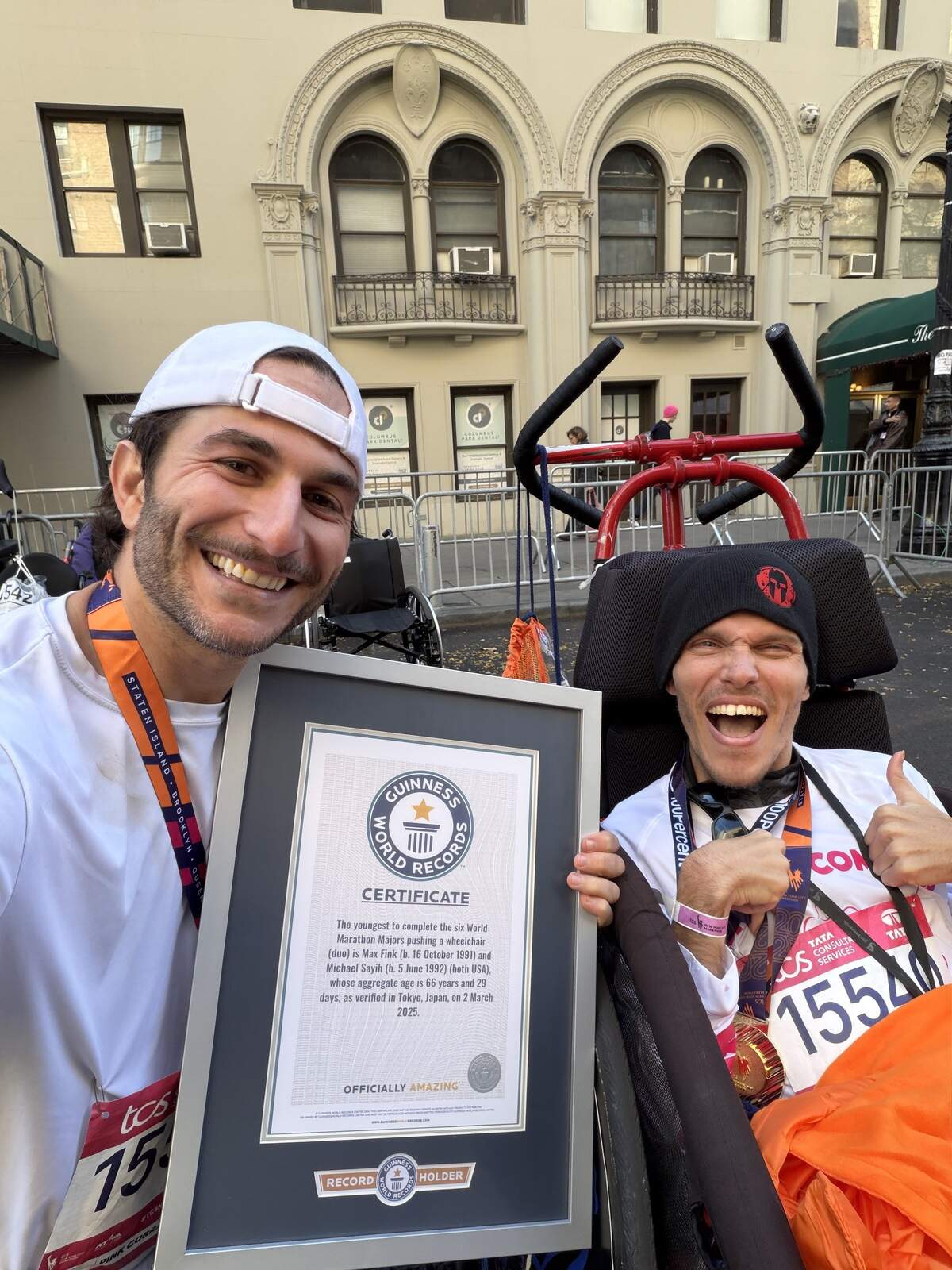 Max Fink, left, and Michael Sayih, right, were awarded the Guinness World Records certificate for being the youngest wheelchair duo to complete the six World Marathon Majors at the 2025 Tokyo Marathon.