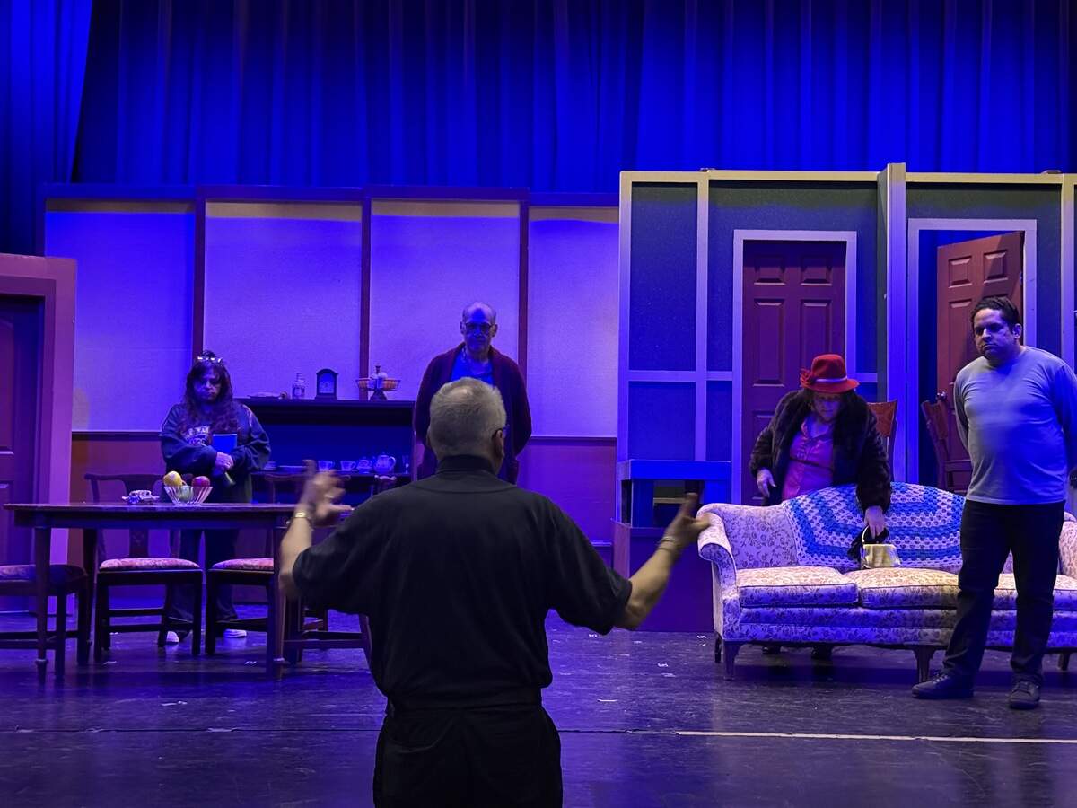 Director Jerry Jensen speaking to some of the cast members during rehearsals.