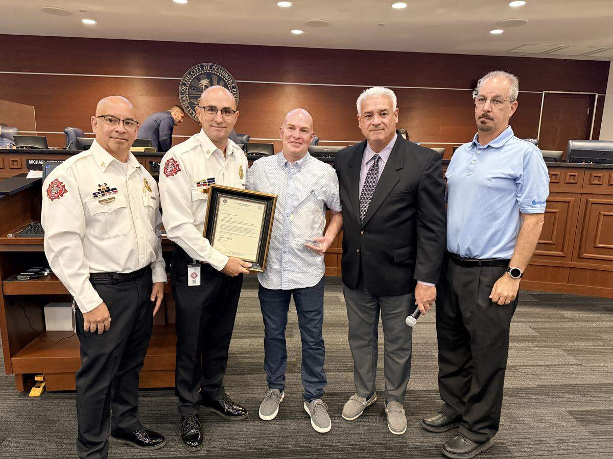 Fire chief Marcelino Rodriguez presented the Civilian Special Recognition Award to Nathan Gansert at the June 3 city commission meeting.