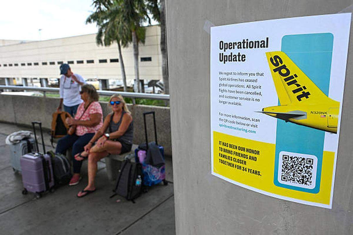 A Spirit Airlines message for customers is seen on a pamphlet after the carrier ceased all operations at Fort Lauderdale-Hollywood International Airport on May 2, 2026. 