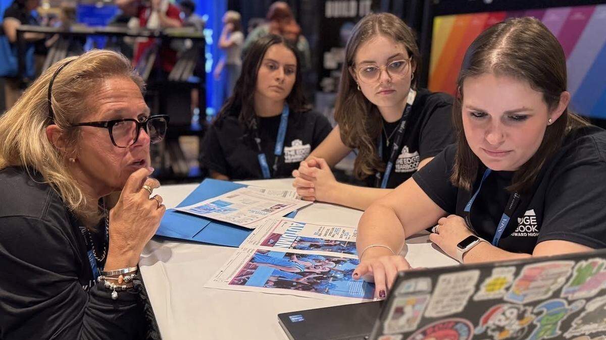 Co-editors-in-chief Thea Larragoite and Erica Zuber, alongside adviser Brooke Acosta, meeting with a Varsity rep to refine the yearbook at the fall 2024 NSPA conference.