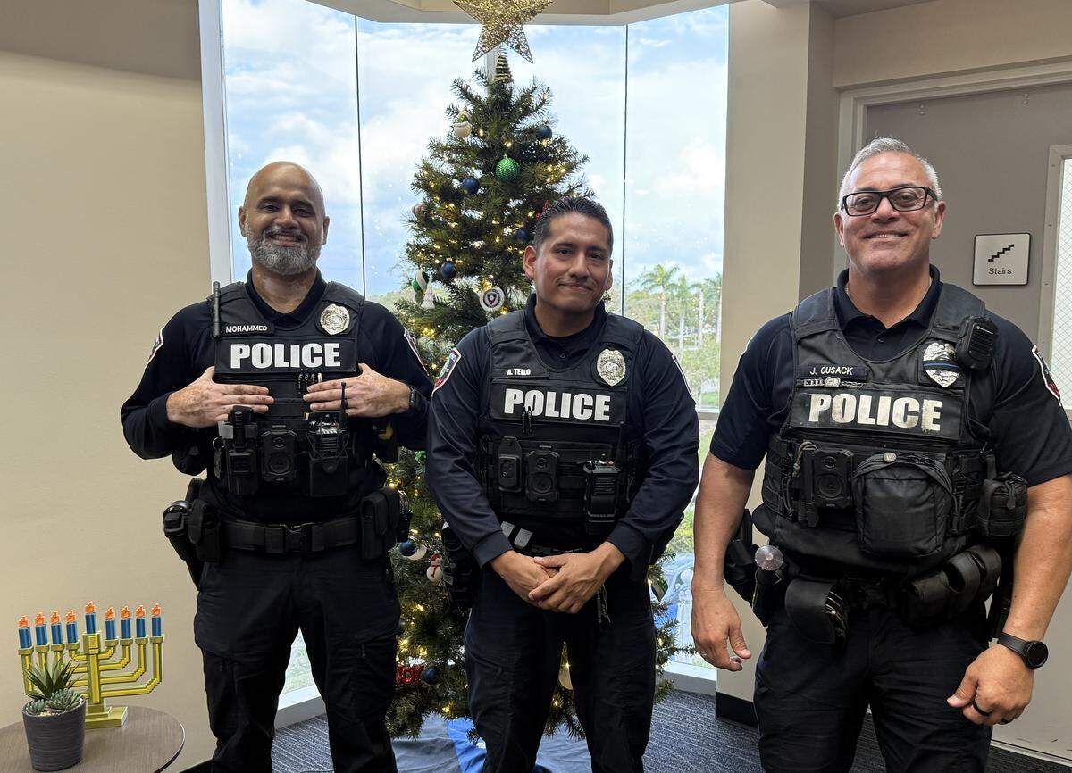 Pembroke Pines police officer (from left) Aameel Mohammed, Anthony Tello and Jon Cusack are pictured at the police station on Dec. 18.