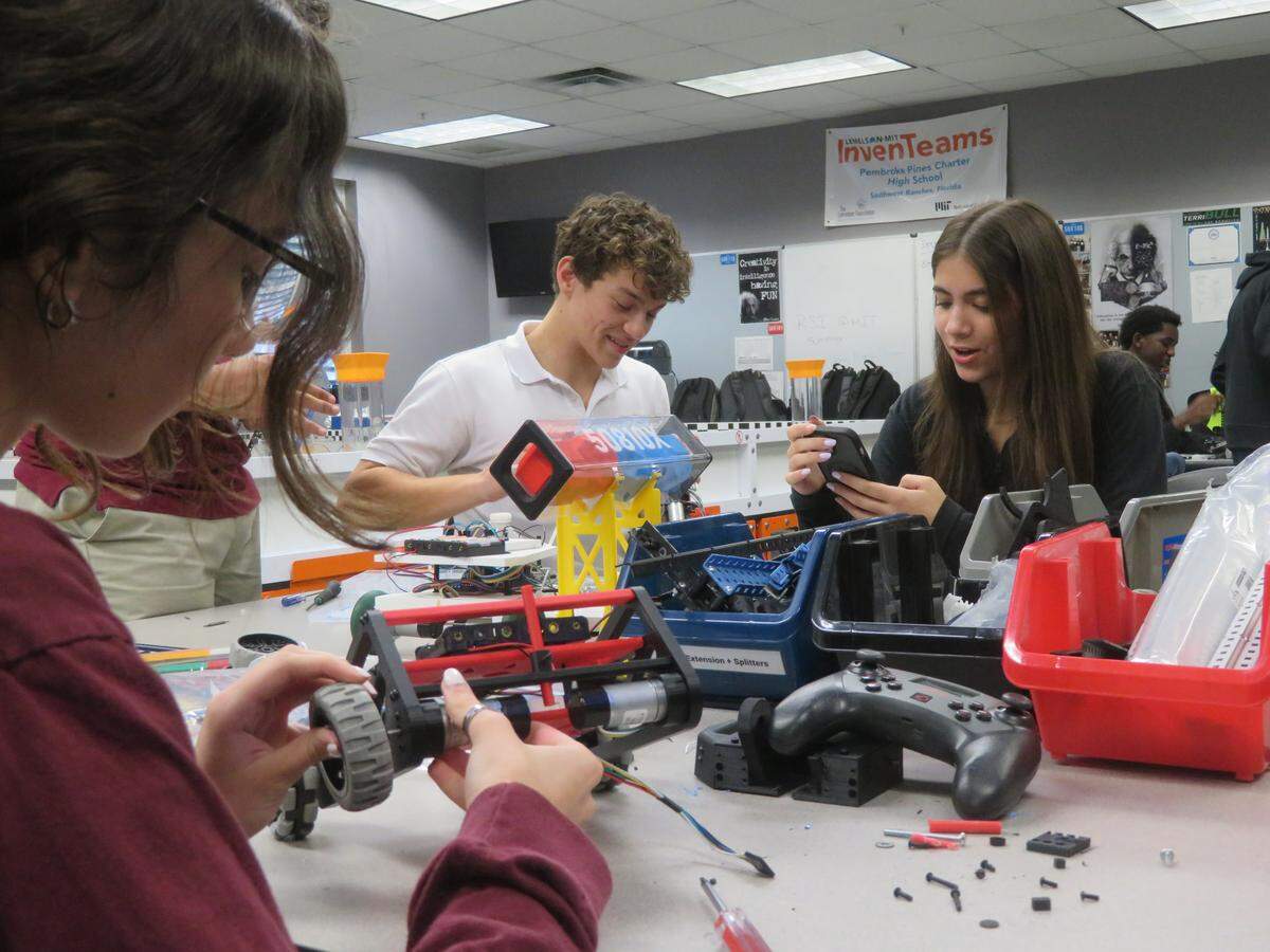 Students from the Lemelson-MIT InvenTeam working in the robotics lab at the Pembroke Pines Charter High School.