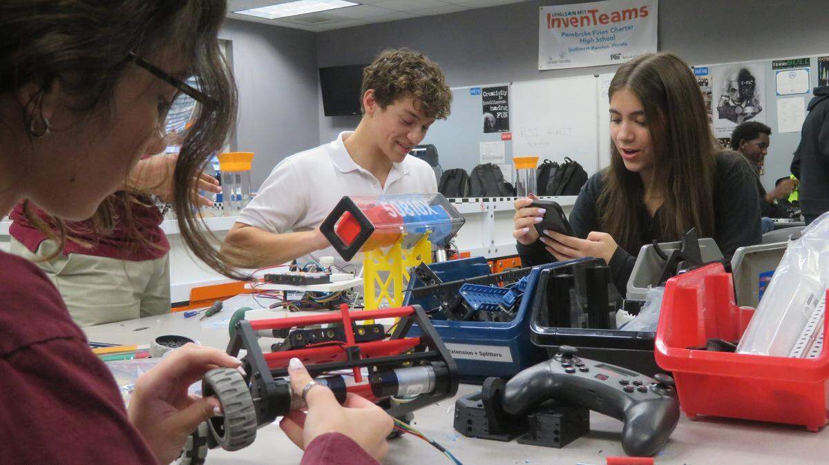 Students from the Lemelson-MIT InvenTeam working in the robotics lab at the Pembroke Pines Charter High School.