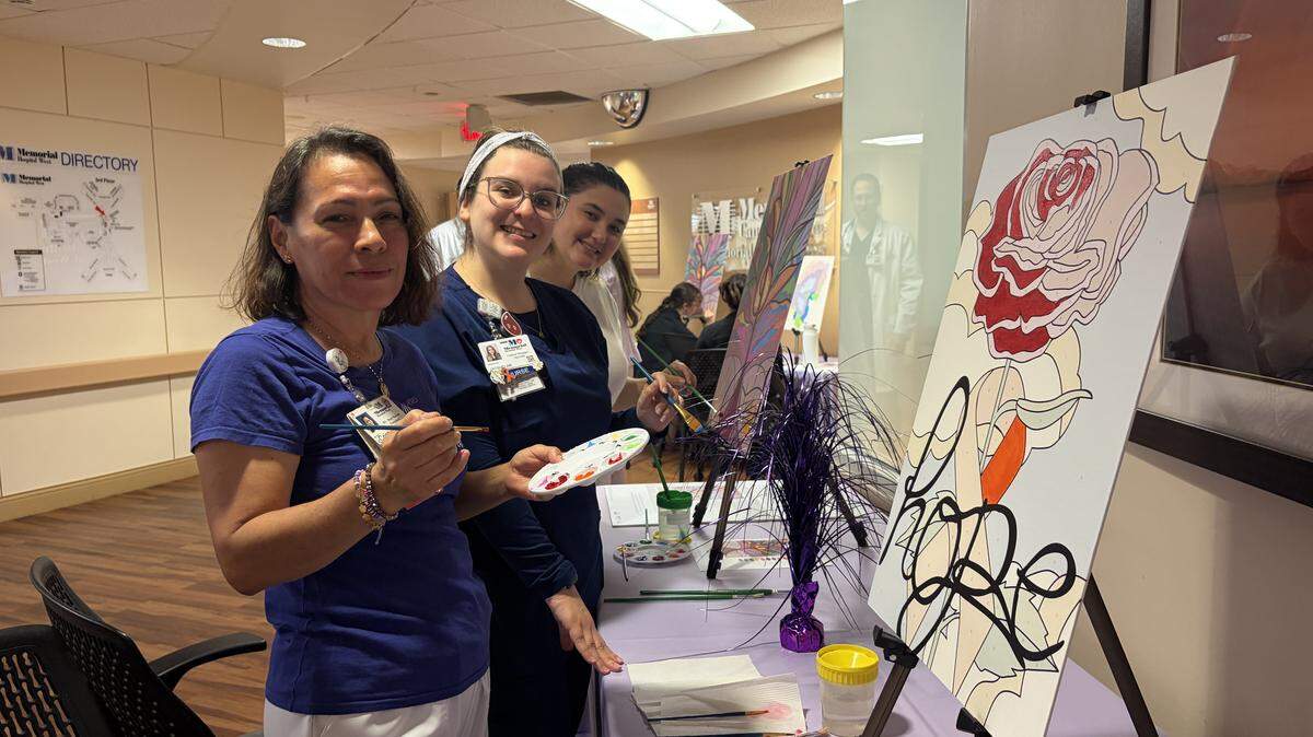 Staff of the Moffitt Malignant Hematology & Cellular Therapy at Memorial Hospital West complete a “paint by the numbers” piece for the center’s new patient art gallery.