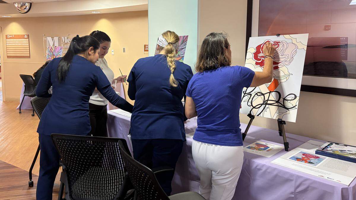 Staff of the Moffitt Malignant Hematology & Cellular Therapy at Memorial Hospital West complete a “paint by the numbers” piece for the center’s new patient art gallery.