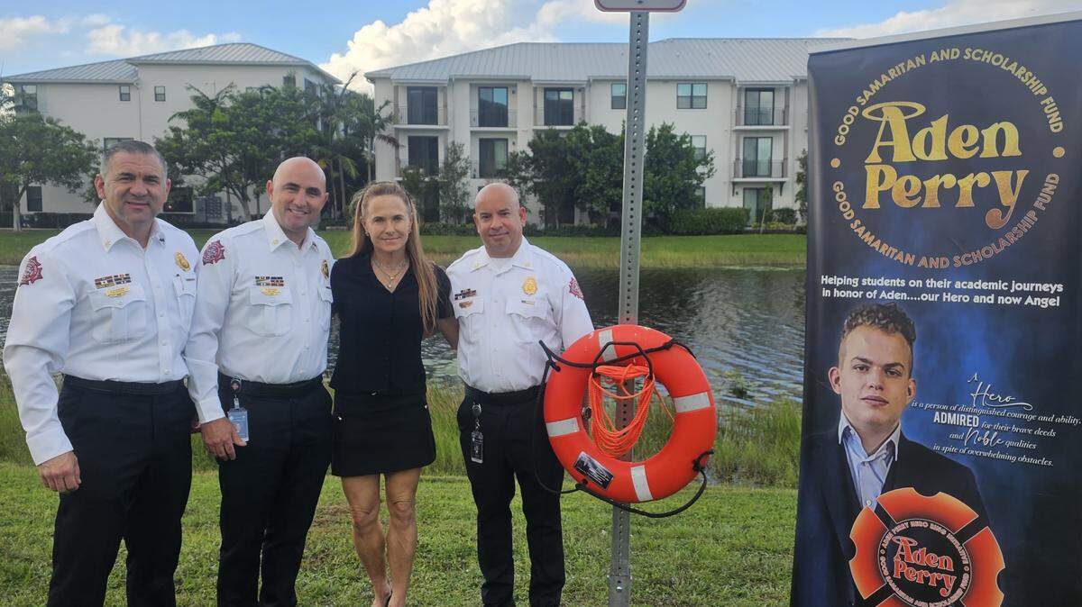 Sarah Perry pictured with Pembroke Pines Fire Department leaders.