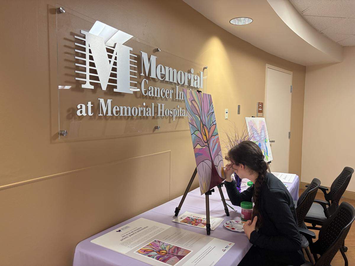 Maya Lamdanski, a secretay at Memorial Hospital West’s oncology department, completes a “paint by the numbers” piece for the center’s new patient art gallery.