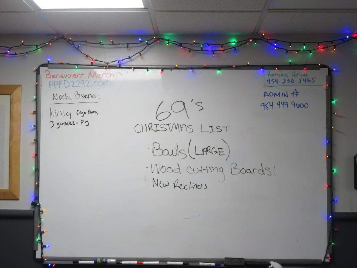 A whiteboard in the dining and kitchen area at Station 69 in Pembroke Pines shows the station’s Christmas list on Dec. 19.