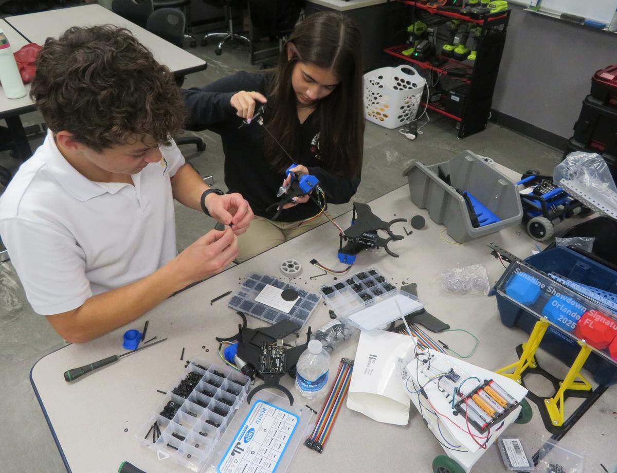 Sophomores John Abohasen and Valentina Glen work after school in the Pembroke Pines Charter High School robotics lab.